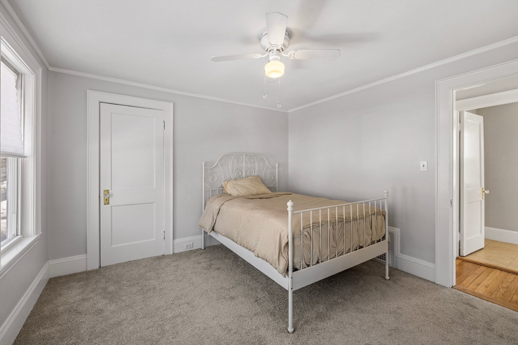 34 Lafayette Street Marblehead, MA 01945 - Photo 16 of 22 a bedroom with a bed and a ceiling fan