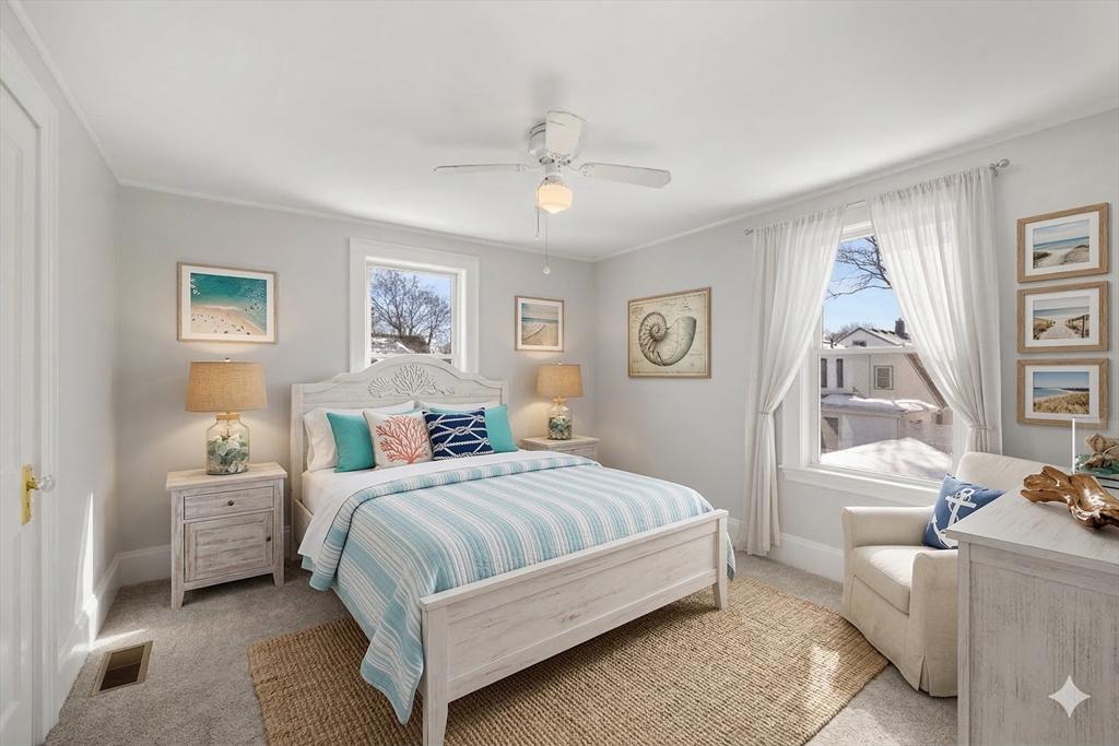 34 Lafayette Street Marblehead, MA 01945 - Photo 18 of 22 a bedroom with a bed and a painting on the wall