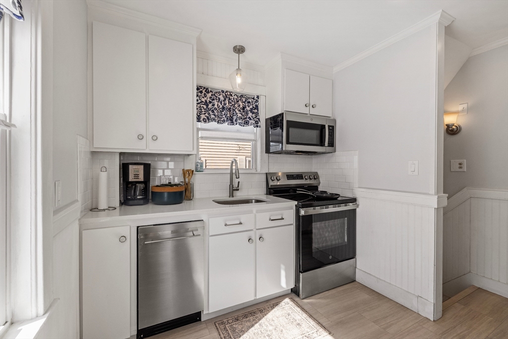 34 Lafayette Street Marblehead, MA 01945 - Photo 10 of 22 a kitchen with stainless steel appliances granite countertop a stove a sink and a refrigerator