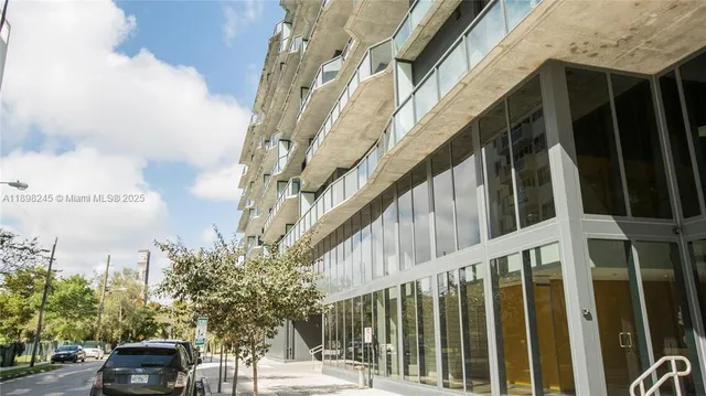 a living room with furniture and a floor to ceiling window