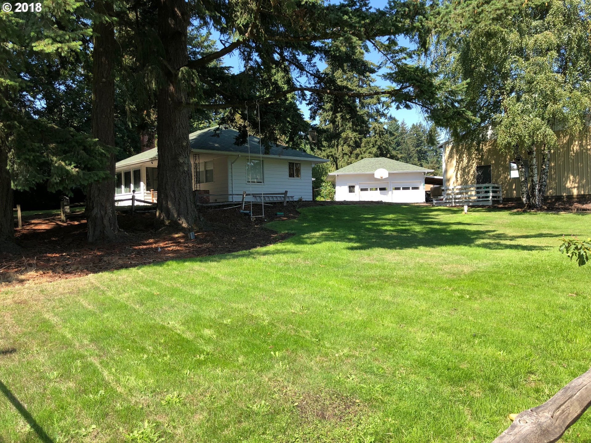13275 Southwest Davies Road Beaverton, OR 97008 - Photo 13 of 22 a front view of a house with a garden and trees