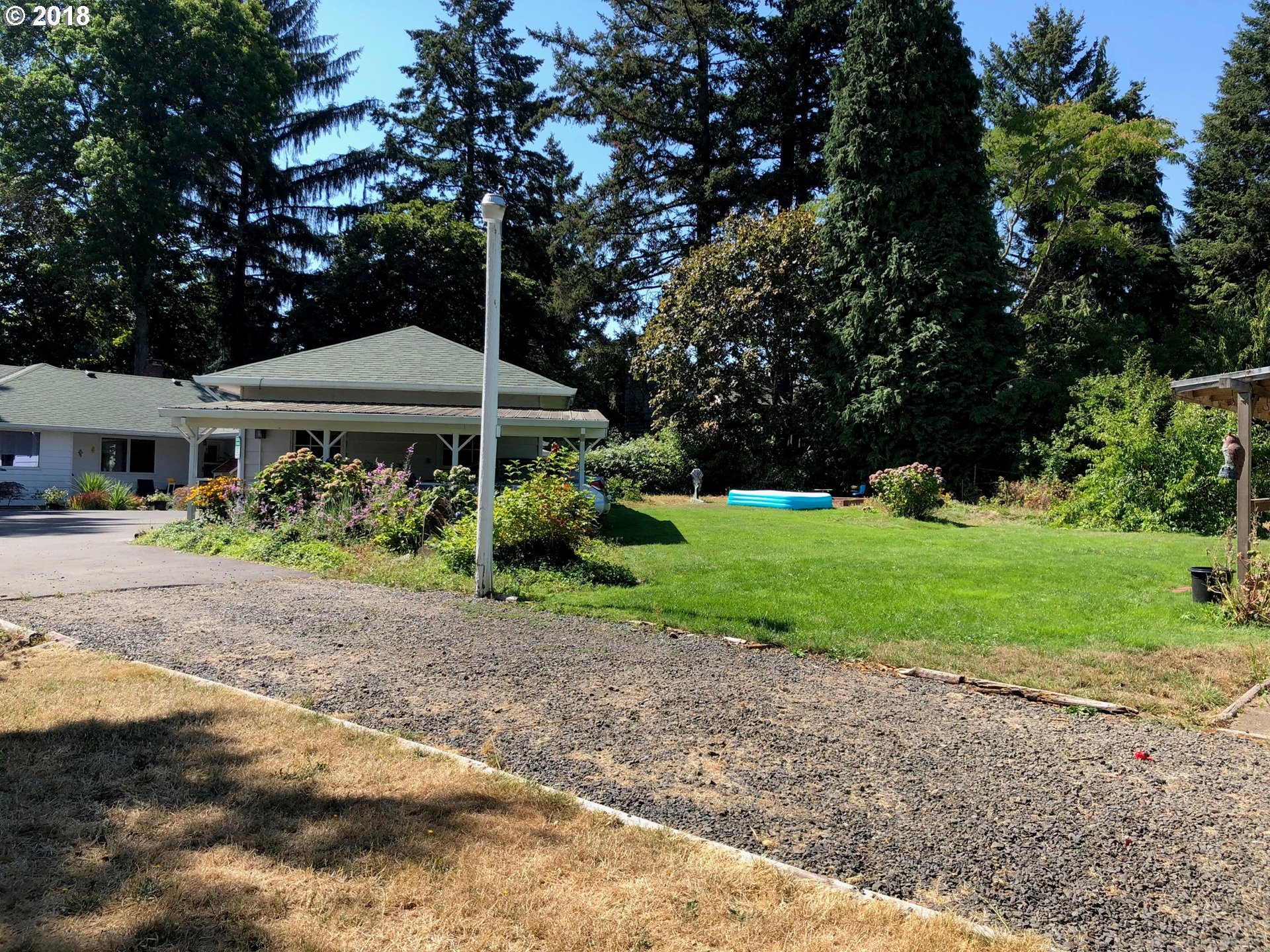 13275 Southwest Davies Road Beaverton, OR 97008 - Photo 18 of 22 a front view of a house with garden