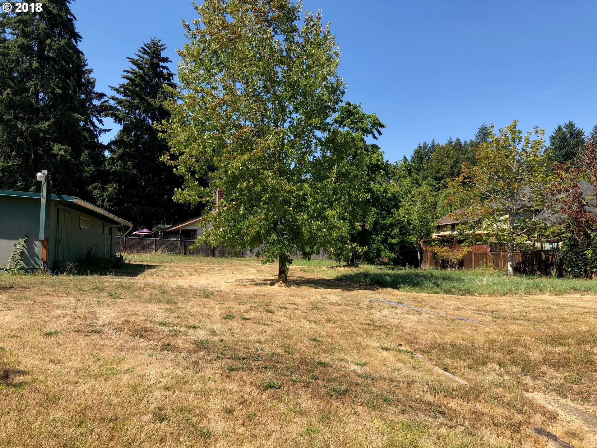 13275 Southwest Davies Road Beaverton, OR 97008 - Photo 20 of 22 a backyard of a house with lots of green space