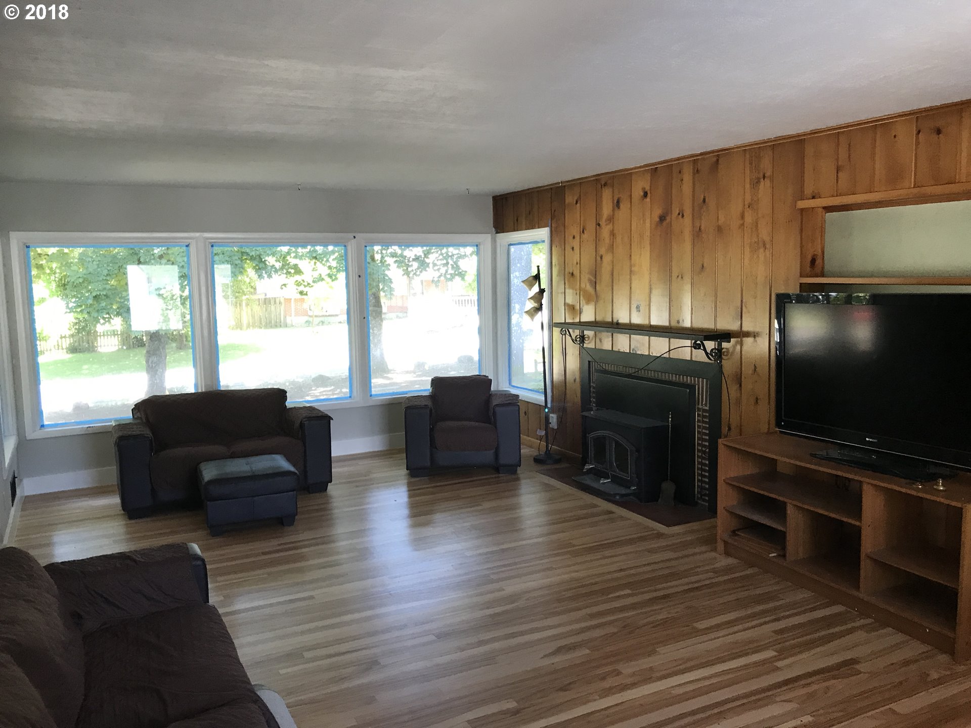 13275 Southwest Davies Road Beaverton, OR 97008 - Photo 6 of 22 a living room with furniture flat screen tv and a fireplace