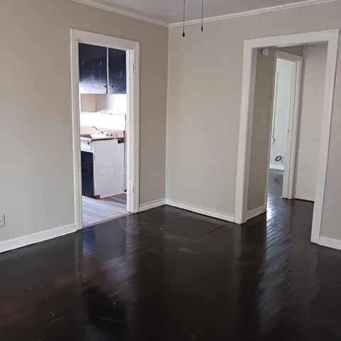 a view of a kitchen with wooden floor and a sink