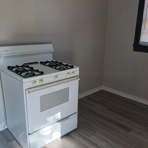 a stove top oven sitting inside of a kitchen