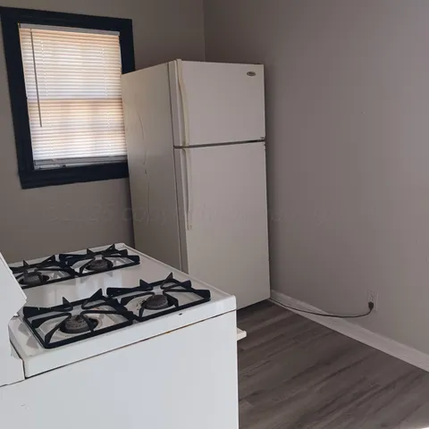 a white stove top oven sitting next to a window