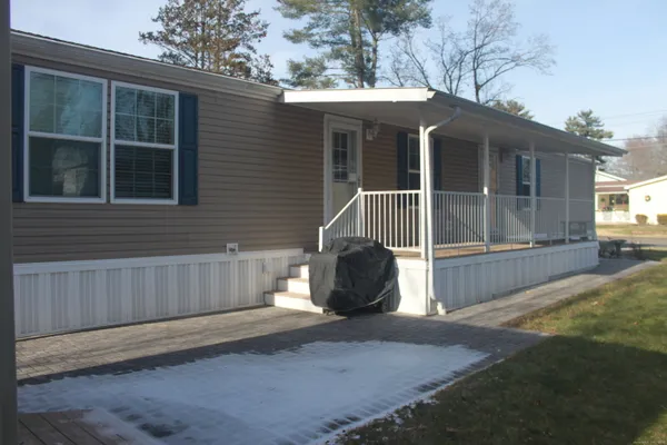 a view of a house with a yard and wooden fence