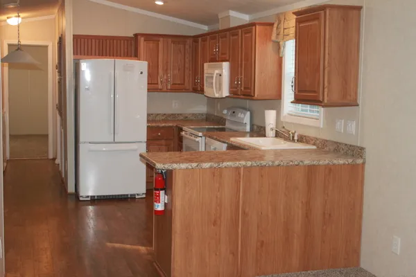 a kitchen with stainless steel appliances granite countertop a refrigerator and a sink