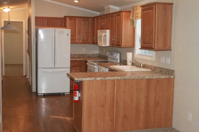 a kitchen with stainless steel appliances granite countertop a refrigerator and a sink