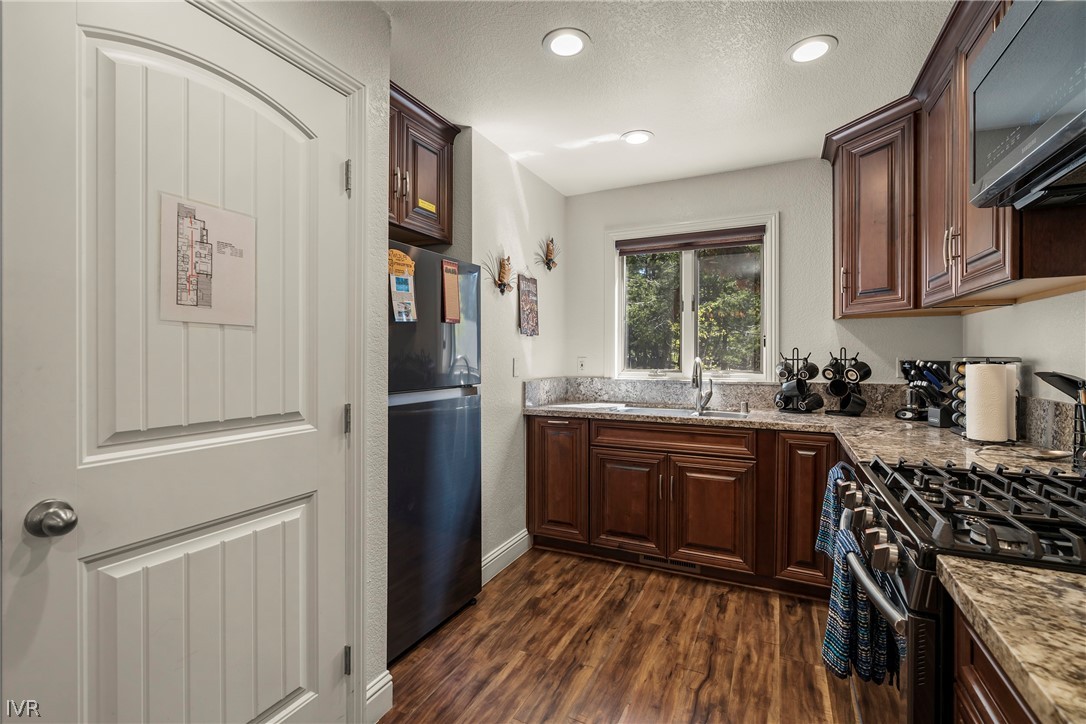 939 Incline Way, Unit 200 Incline Village, NV 89451 - Photo 4 of 27 a kitchen with stainless steel appliances granite countertop a refrigerator and a sink