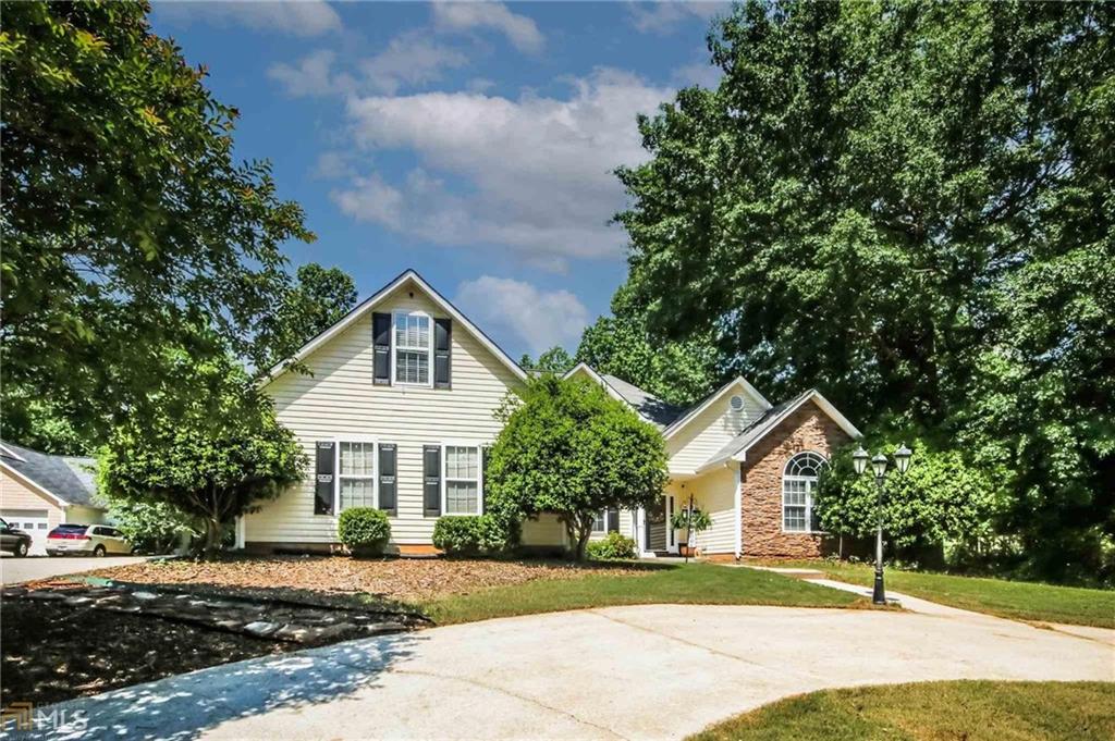 7326 Raleigh Way Bethlehem, GA 30620 - Photo 1 of 1 a front view of a house with a yard and garage