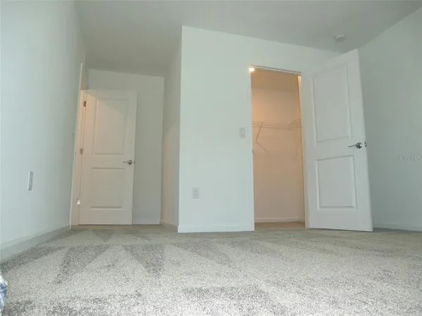 an empty room with closet area