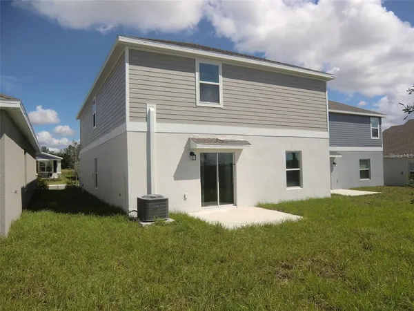 a view of an house with backyard porch and furniture