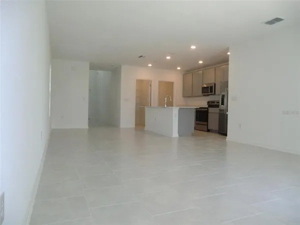 a view of kitchen and refrigerator in a room
