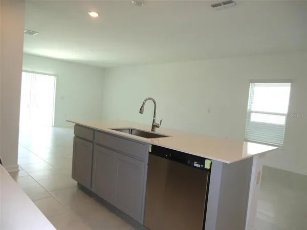 a kitchen with a sink and a mirror