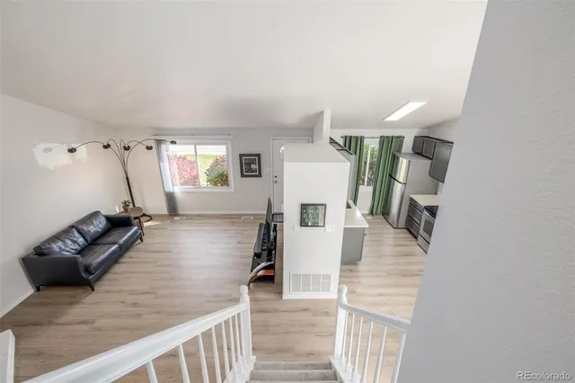 a view of a living room and entryway with wooden floor