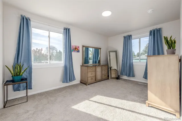 a view of a livingroom with furniture and a window