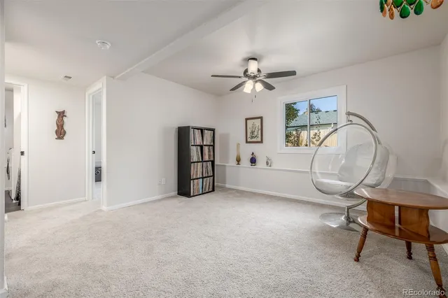 a view of a livingroom with a furniture and a ceiling fan