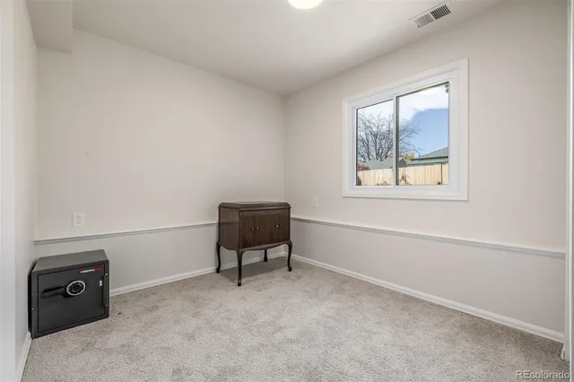 a room with a window and a bed