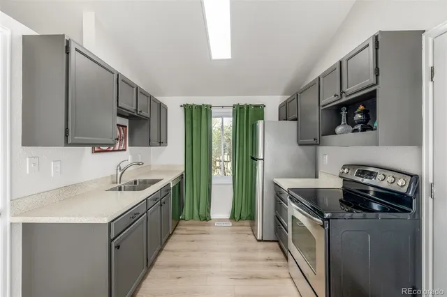 a kitchen with a sink stove and refrigerator