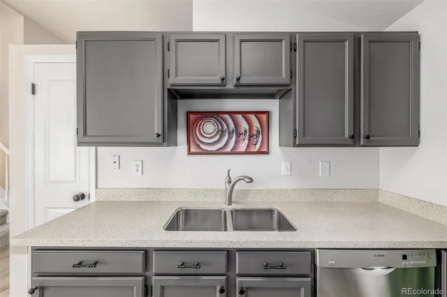 a kitchen with a sink and cabinets