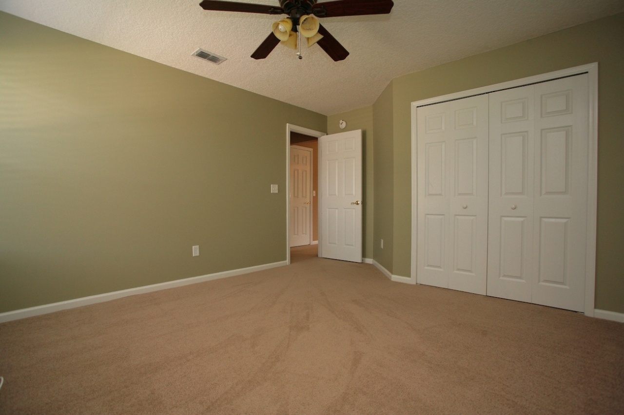 2536 Benjamin Road Jacksonville, FL 32223 - Photo 15 of 25 an empty room with a ceiling fan and carpet