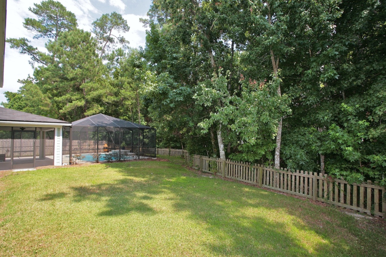 2536 Benjamin Road Jacksonville, FL 32223 - Photo 21 of 25 a view of a house with a yard and fence