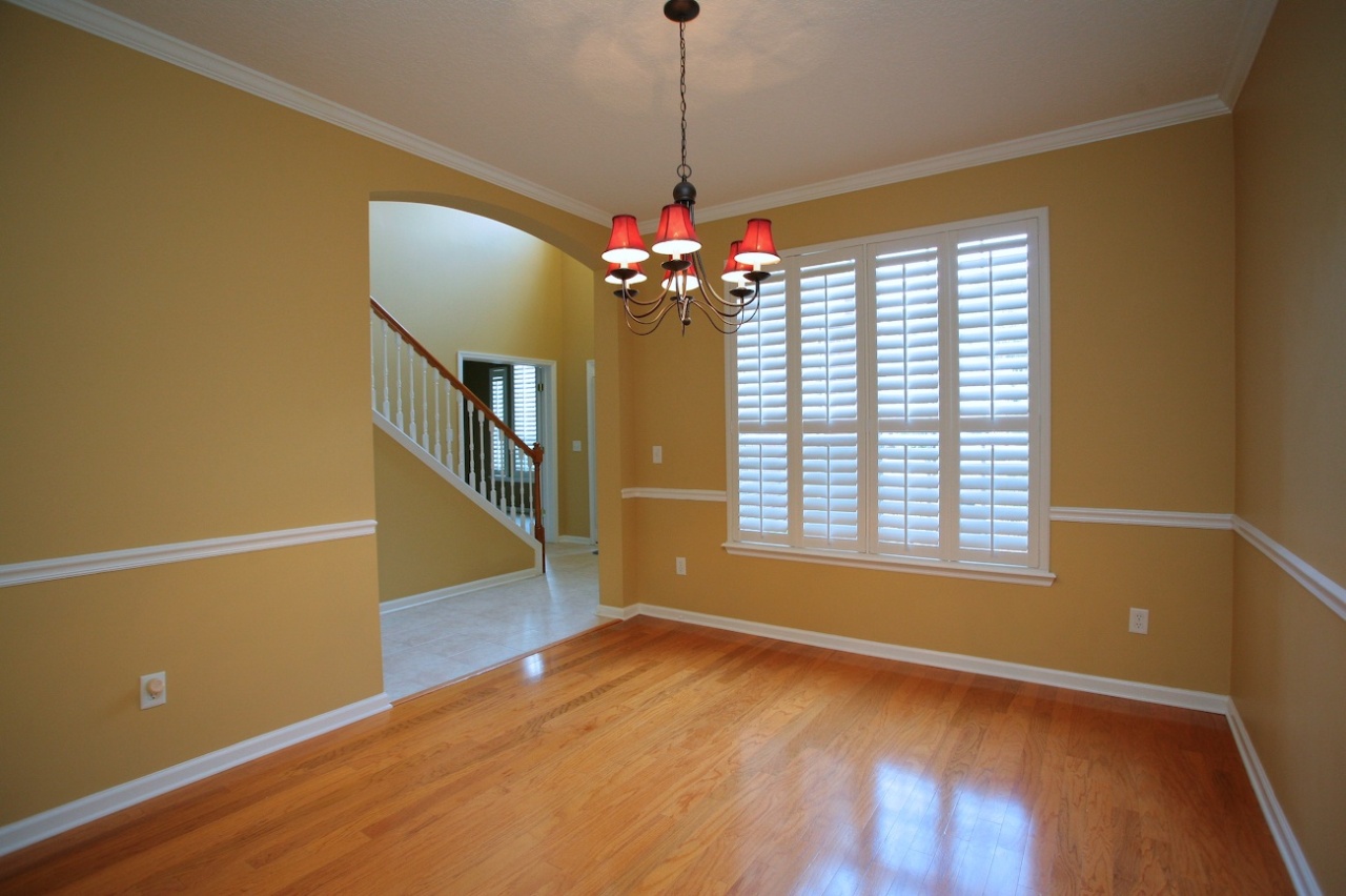 2536 Benjamin Road Jacksonville, FL 32223 - Photo 3 of 25 a view of an empty room with wooden floor and a window