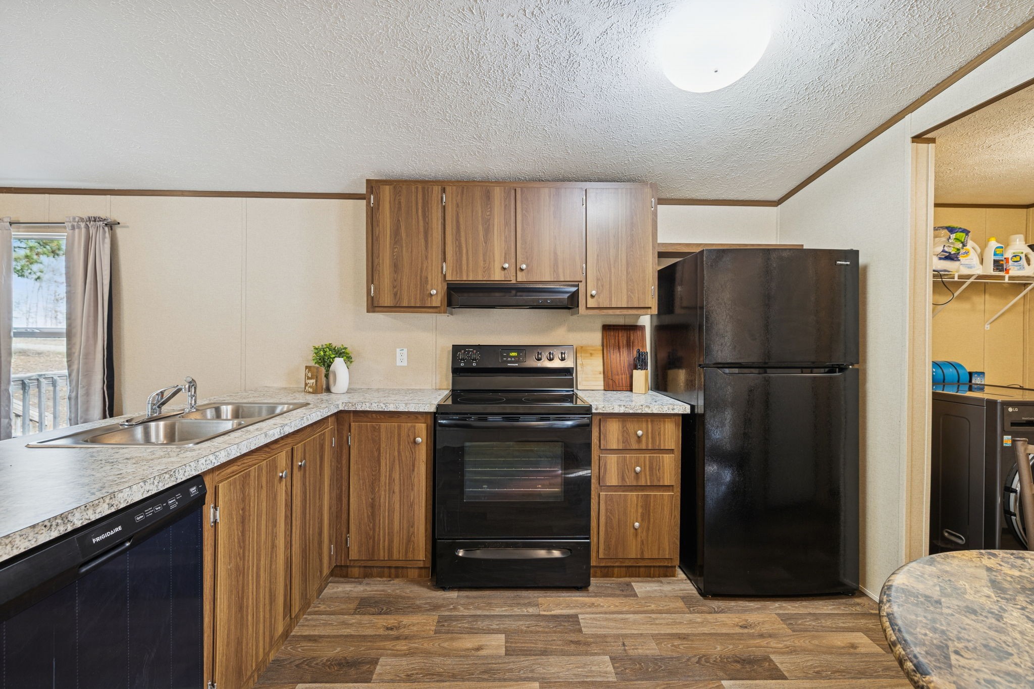 108 Lyell Road Hohenwald, TN 38462 - Photo 9 of 28 a kitchen with a refrigerator and a sink