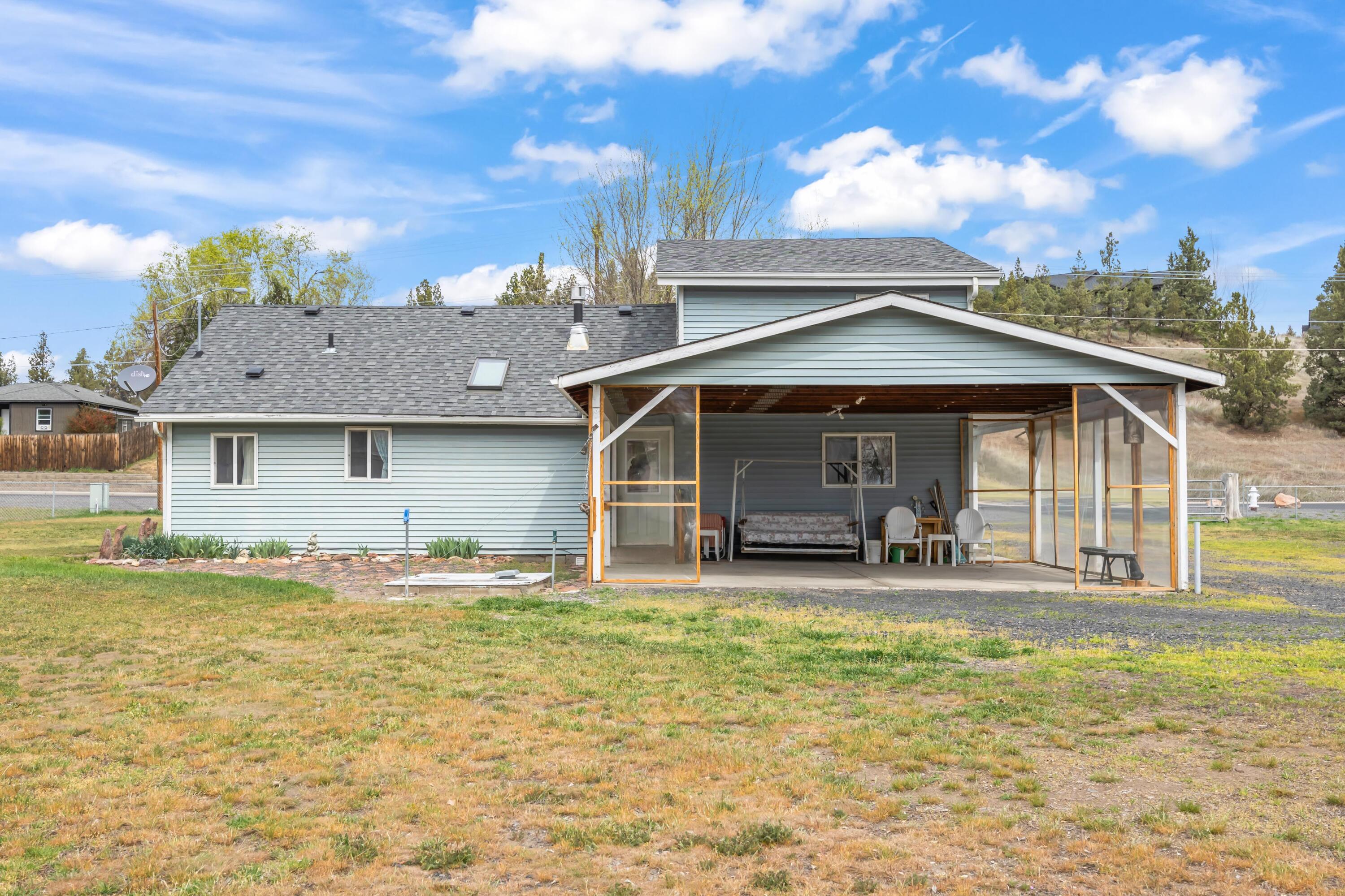 2010 Northeast Laughlin Road Prineville, OR 97754 - Photo 23 of 39 a front view of a house with swimming pool and porch with furniture