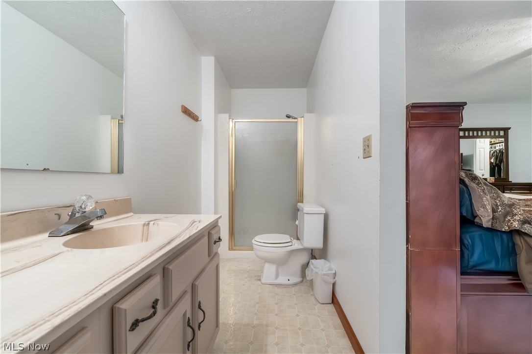 4922 South Ridge Road East Geneva, OH 44041 - Photo 21 of 46 Private primary ensuite bathroom featuring an extended vanity, dedicated walk-in shower with
frosted glass door, and neutral finishes.