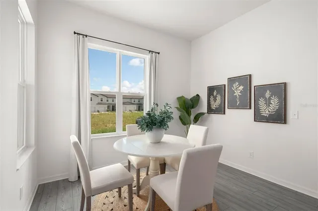 a dining room with furniture and window