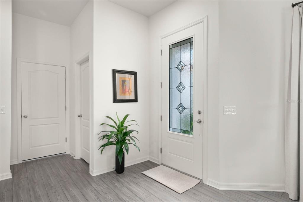 685 Poppy Lane Dundee, FL 33838 - Photo 12 of 31 an entryway with wooden floor and a potted plant
