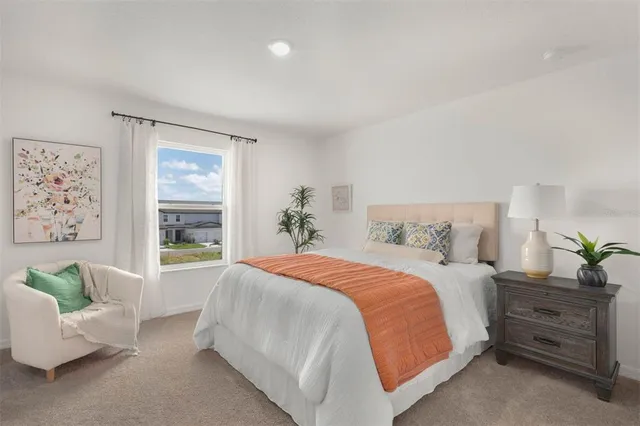 a bedroom with a large bed and a couch