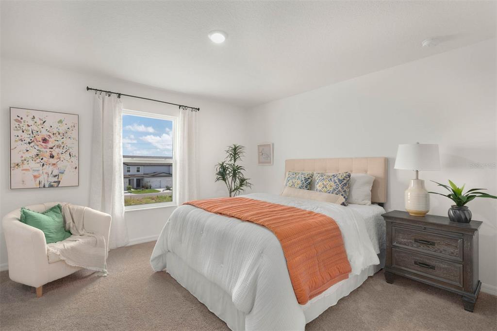685 Poppy Lane Dundee, FL 33838 - Photo 17 of 31 a bedroom with a large bed and a couch