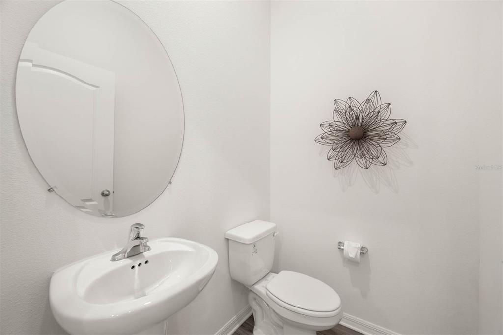 685 Poppy Lane Dundee, FL 33838 - Photo 22 of 31 a bathroom with a toilet sink and mirror
