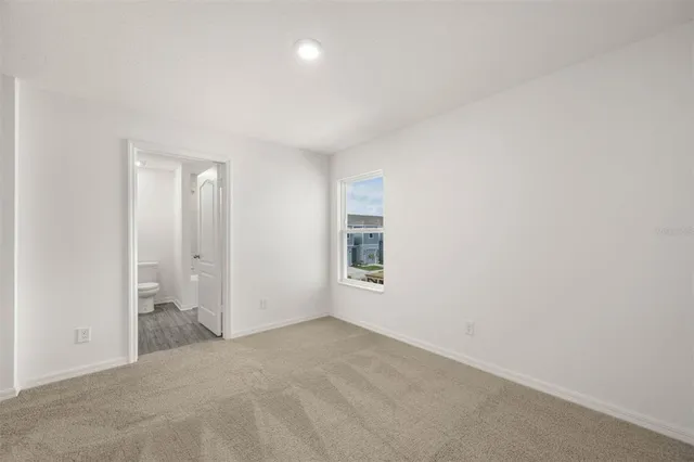 an empty room with a empty space and windows