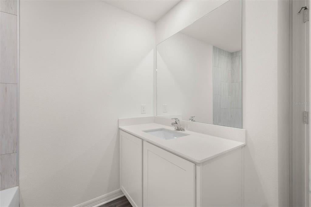 685 Poppy Lane Dundee, FL 33838 - Photo 25 of 31 a bathroom with a sink and a mirror