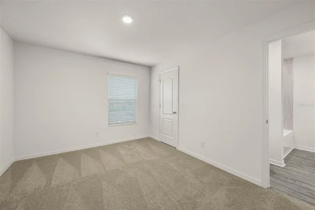 an empty room with a empty space and windows