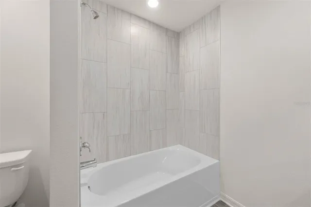 a bathroom with a white bath tub and a shower curtain
