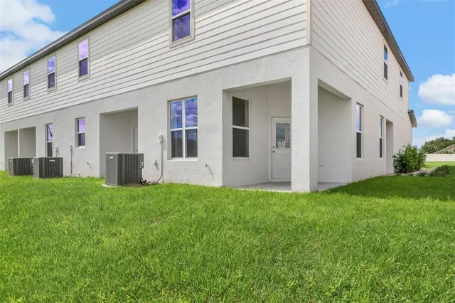a view of a house with backyard and garden