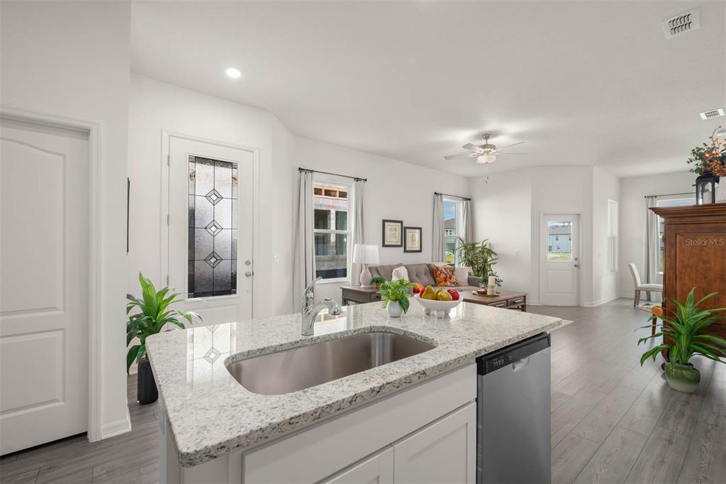 685 Poppy Lane Dundee, FL 33838 - Photo 6 of 31 a kitchen with a sink and a refrigerator