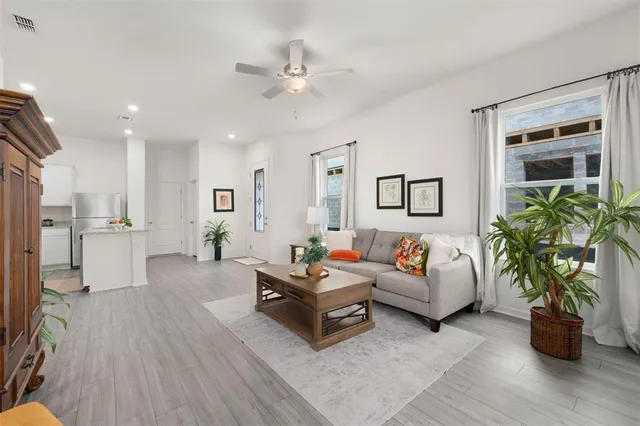 a living room with furniture and wooden floor