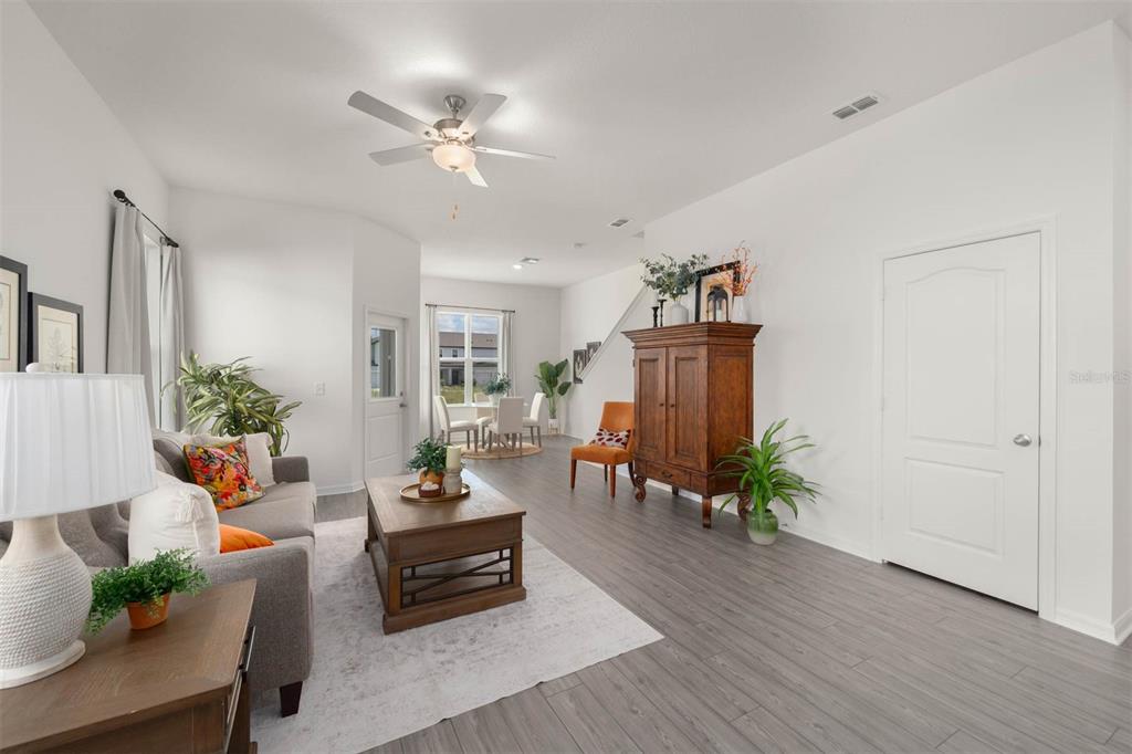 685 Poppy Lane Dundee, FL 33838 - Photo 9 of 31 a living room with furniture and wooden floor