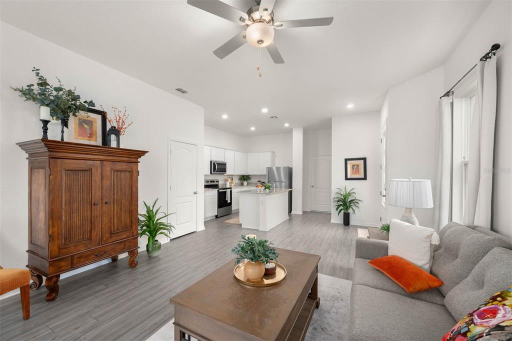 685 Poppy Lane Dundee, FL 33838 - Photo 10 of 31 a living room with furniture kitchen view and a potted plant