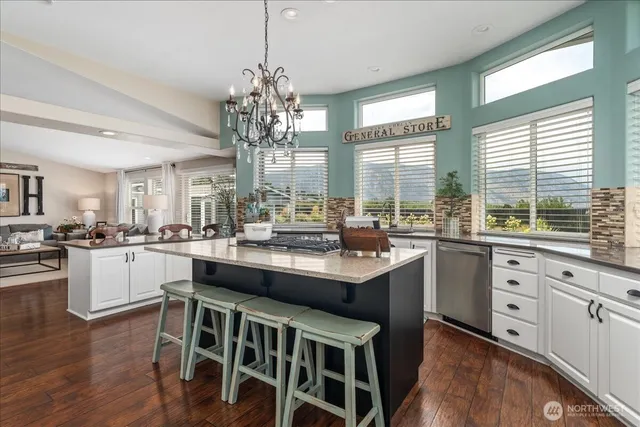 a kitchen with sink cabinets and wooden floor