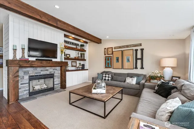a living room with furniture a fireplace and a flat screen tv