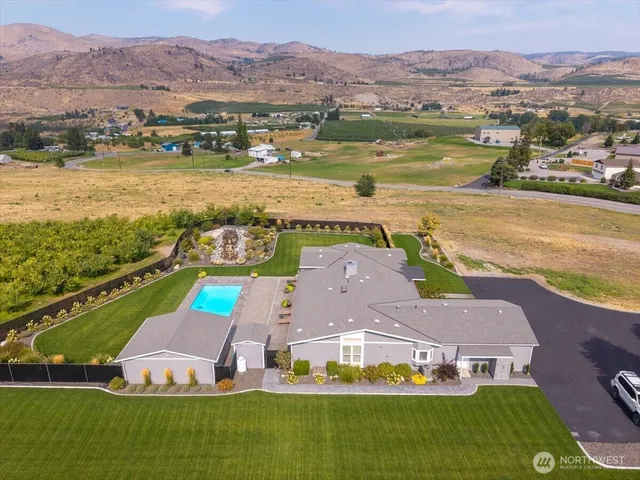 an aerial view of residential houses with outdoor space and river