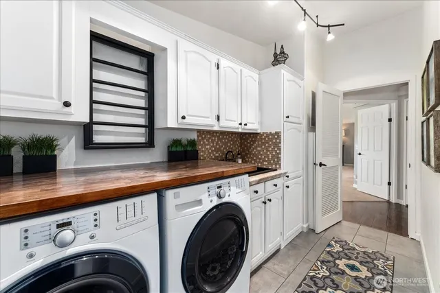 a bathroom with double vanity and a mirror